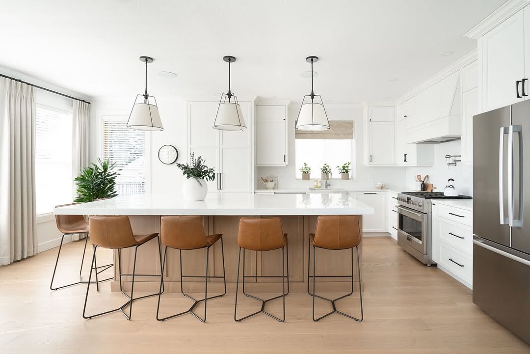 Main kitchen after renovation with bright white cabinetry and large island
