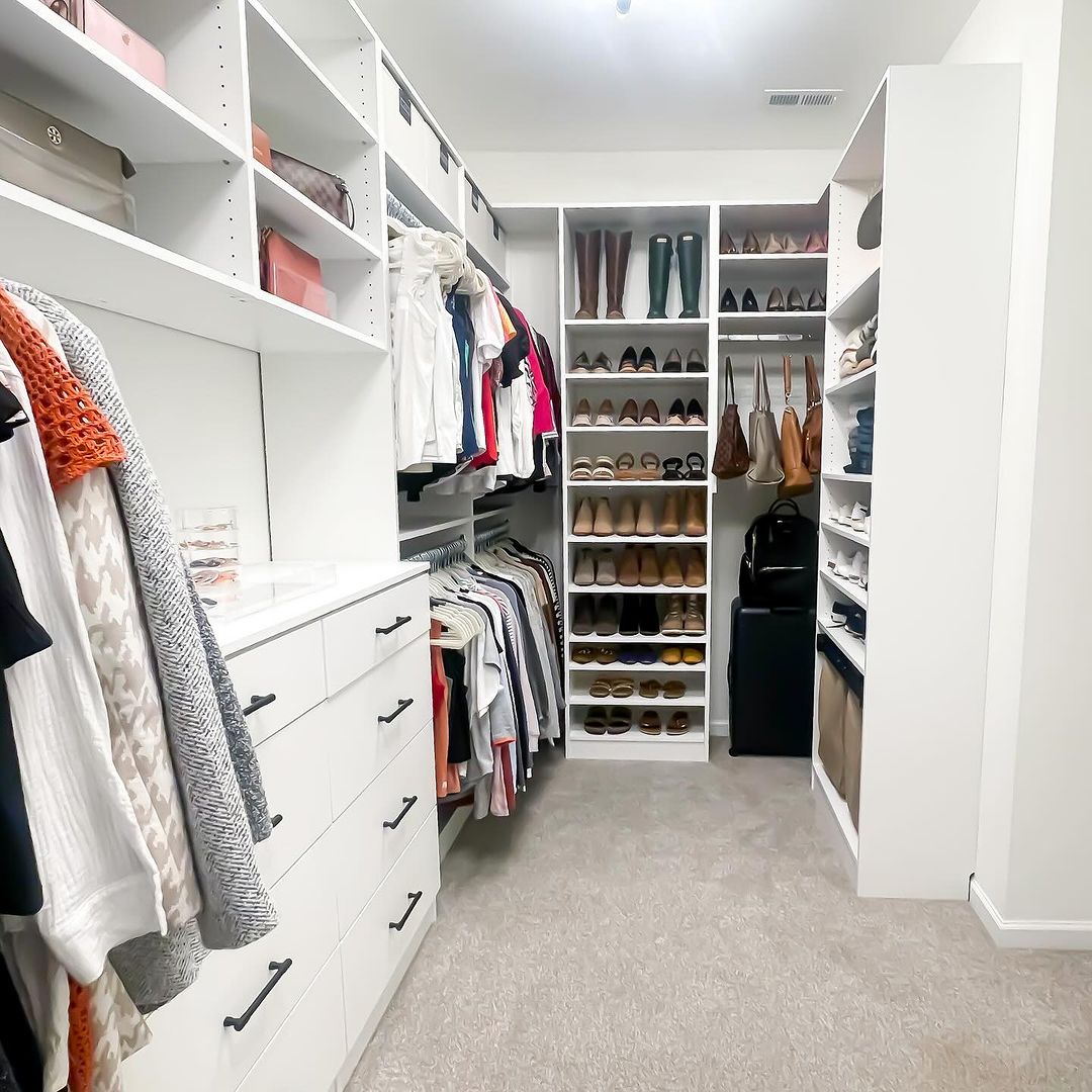 Walk-in closet after renovation with built-in shelving and drawers