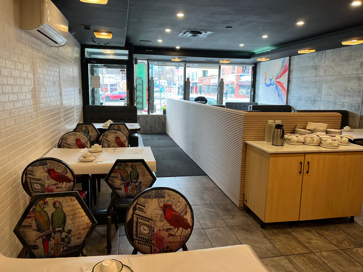 Completed restaurant seating area with partition and storefront light