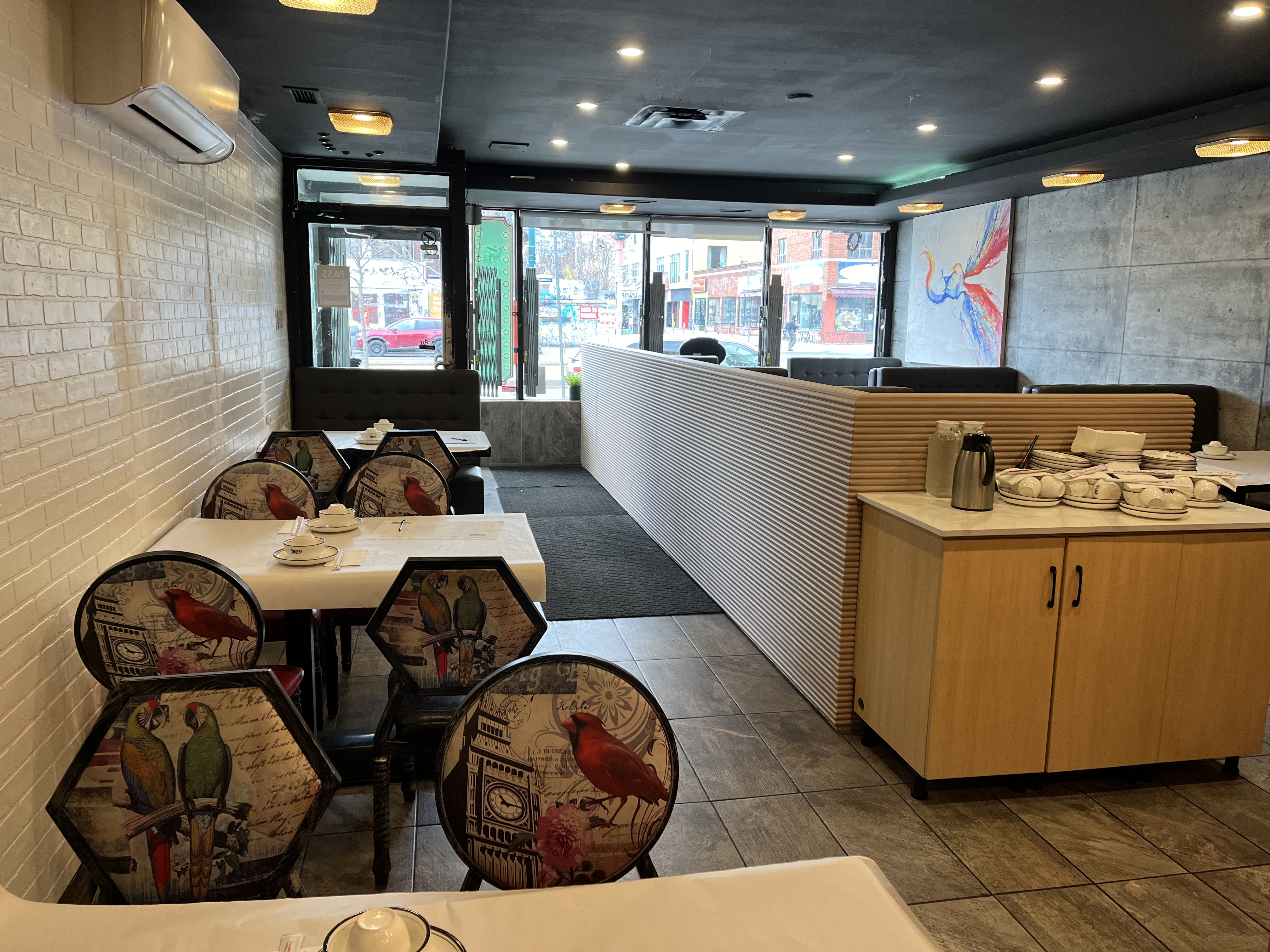 Restaurant seating area with partition, wall finishes and storefront light