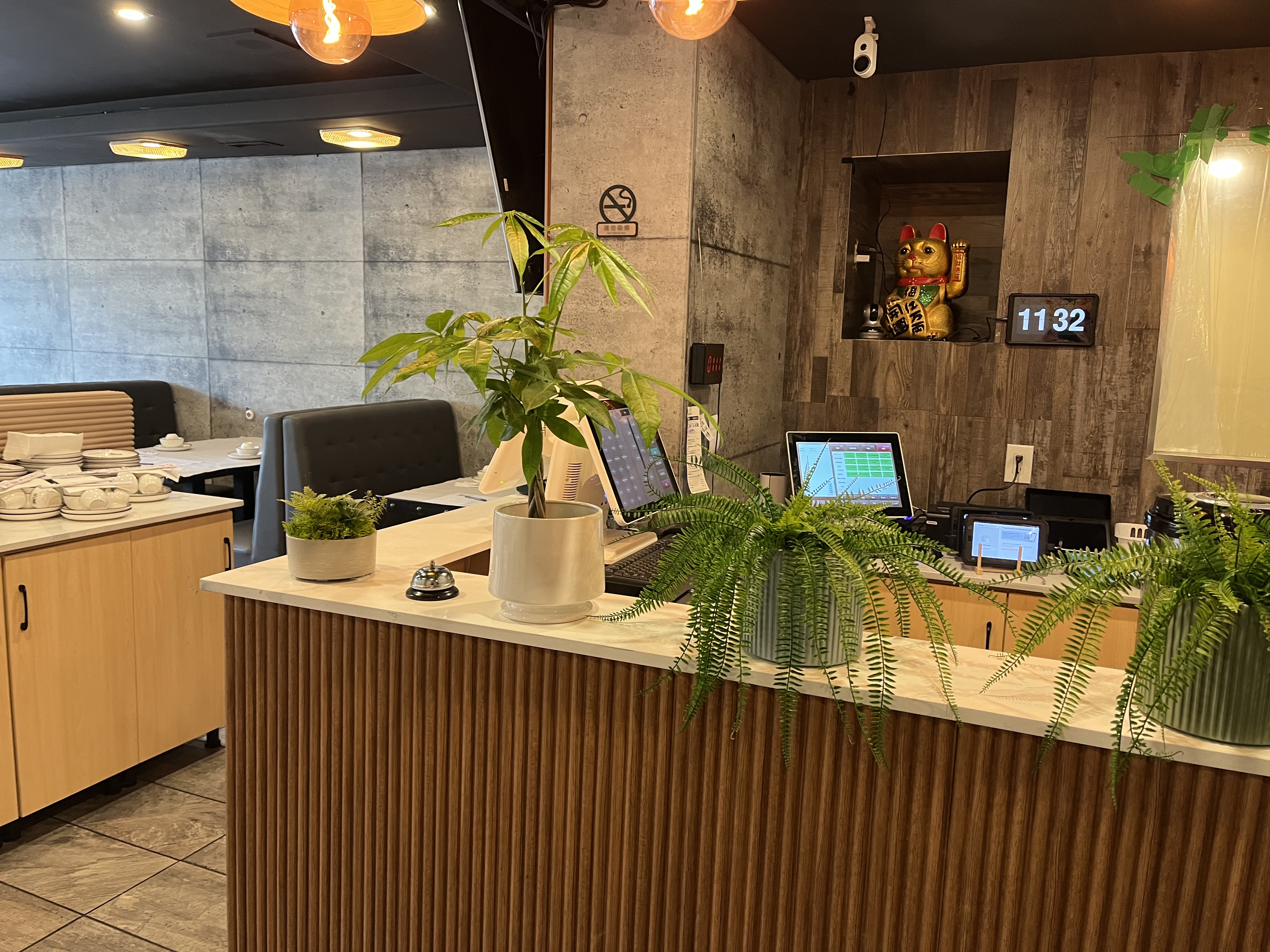 Restaurant service counter with wood slat millwork and plants